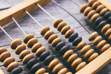 Vintage wooden abacus on old board surface. © pictures_for_you