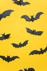 Fototapeta premium Halloween paper vampire bat decorations on an orange background.