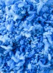 Natural woolen fabric fragment. Knitted texture closeup. Warm yarn background.