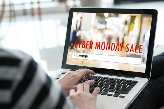 Woman hands typing laptop computer with www. on search bar over cyber monday sale banner background, Online shopping, business and technology