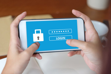 Hand using tablet with password login on screen, cyber security concept