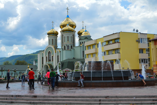 Young people running around a fountain in Khust, Ukraine on May 3, 2016.