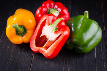 Three sweet peppers on a wooden background, Cooking vegetable salad