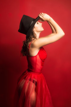 beautiful woman portrait in red dress and a hat