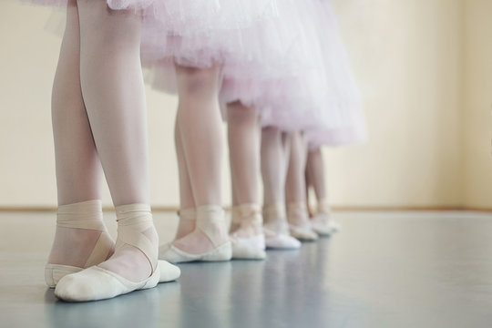 Little dancers legs in pointe shoes, making exercises