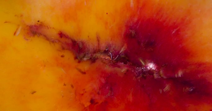 Crush Pulp Ripe Peach. Slices of fragrant ripe Peach are compressed and crushed close-up on a bright white background, creating a juicy stream of Pulp and shell. Shooting at 120fps