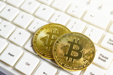 Close up gold of bitcoins on keyboard computer for business concept.