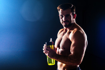 Muscular fitness man antique statue perfect muscles six pack abs and sexy bare nude chest bodybuilder Apollo model drinking water from a bottle black background competition functional training