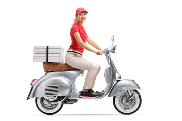 Fototapeta na wymiar Smiling pizza delivery woman on a scooter with pizza boxes