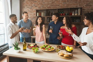 Group of friends talking during home party