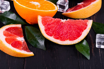orange and grapefruit juice On a wooden black background