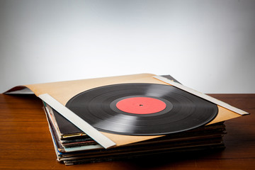 Vinyl record on stack of covers