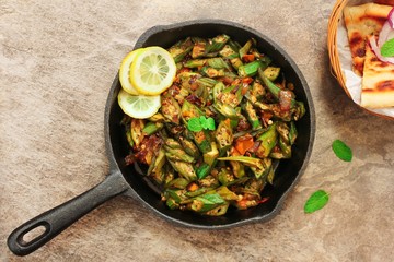 Homemade Bhindi Masala / Okra fry served with Roti, overhead view