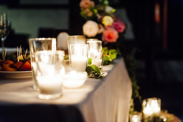 Rustic wedding decor on a timber background. Main table setting for bride and groom newlyweds