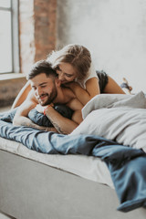 
beautiful loving couple kissing in bed