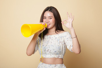Beautiful young Asian woman show OK  announce with megaphone.