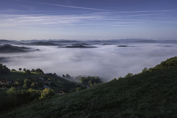 Panoramic foggy landscape in Styria in autumn morning, Slovenia