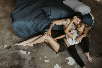 Beautiful loving couple kissing in bed
