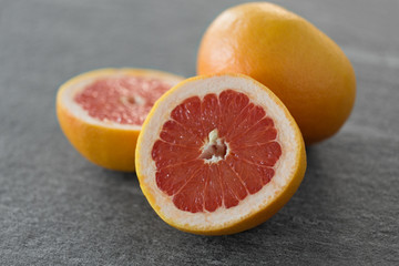 food, fruits and healthy eating concept - close up of fresh juicy grapefruits
