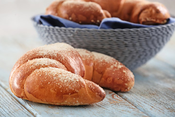 Tasty fresh crescent rolls on wooden  table