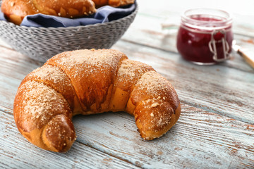 Tasty fresh crescent roll on wooden  table