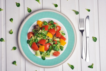 vegetables salad with spinach, cherry tomatoes, corn salad, baby spinach, fresh mint and basil. Home made food. Concept for a tasty and healthy meal