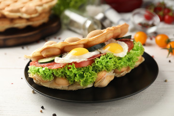 Delicious bubble waffle with fried eggs on plate
