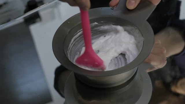 process of mixing of components for reception without an aldehyde paint in a beauty salon. slow motion