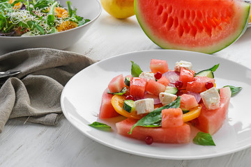 Plate with delicious watermelon salad on white table