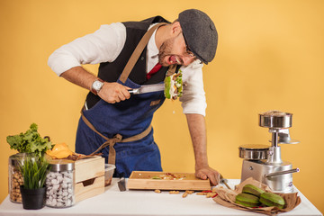 Hungry man is going to swallow half of appetising beef burger, he just made. Unhealthy food, People and Fastfood concept
