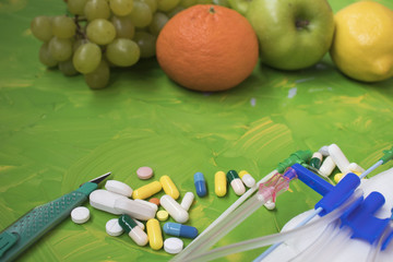 Colorful healthy medicinal fruits on a colorful background with drugs on the other side-the concept of food and nutrition