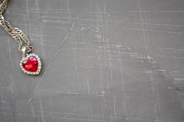 chain with a heart on a concrete background, a place to place labels and advertising, copy space