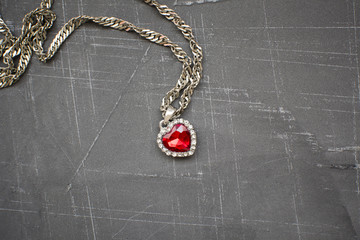 chain with a heart on a concrete background, a place to place labels and advertising, copy space