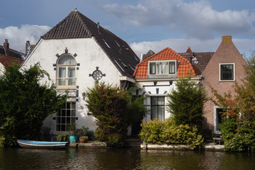 20 August 2018, Leiden, Netherlands:Reflection of the tradional Dutch houses in canal water