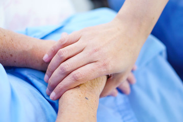  Touching hands Asian senior or elderly old lady woman patient with love, care, helping, encourage and empathy at nursing hospital ward : healthy strong medical concept 