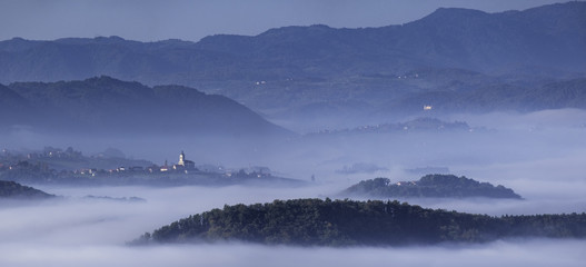 Foggy landscape in Styria with the church Saint Ema (Hemma) and castle near Podcetrtek, Slovenia