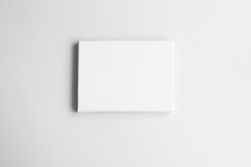 White canvas on gray wall. Mock-up poster frame in interior.