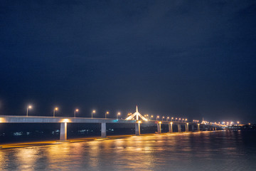 Fototapeta premium Second Thai–Lao Friendship Bridge at Night with Water Reflection