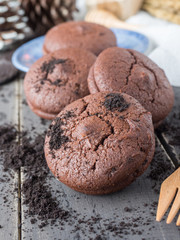 Chocolate cookies and brownie biscuit on black wood table.