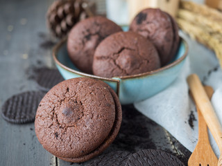 Chocolate cookies and brownie biscuit on black wood table.