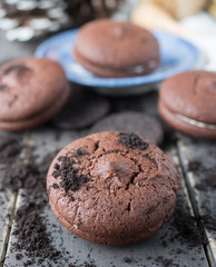 Chocolate cookies and brownie biscuit on black wood table.