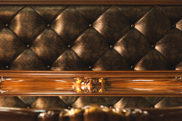 Close-up Gold fabric upholstered headboard with buttons textile background, retro Stylish bedroom furniture with reflection in the mirror