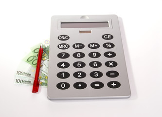 A large calculator with a red pen and the bills of a hundred euros on a white background