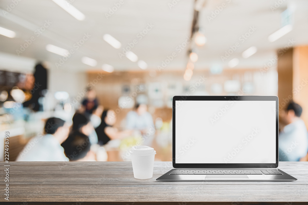 Poster laptop with blank screen placed on wooden table blurred people meeting background ,startup business 