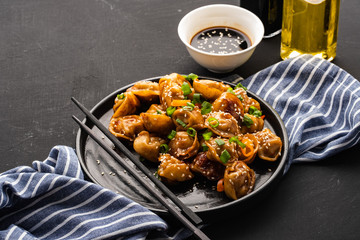 Fried dumplings with soy sauce with pepper and green onions. Asian cuisine