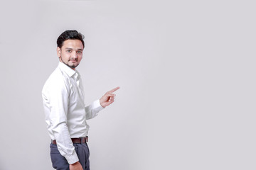 Young Indian man showing on white background