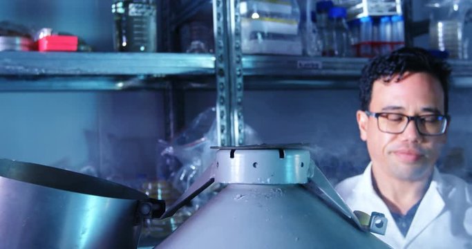 Two scientists covering the lid of barrel 4k