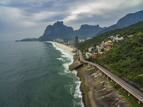 Highway by the sea. Wonderful road and bike path. Bicycle and road track and next to the blue sea in the city of Rio de Janeiro. Tim Maia bike path on Niemeyer Avenue, Rio de Janeiro, Brazil.