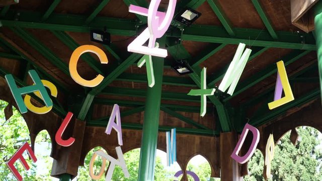 Alphabet Letters Hanging On Roof. Alphabet letters hanging outside on a roof of a gazebo