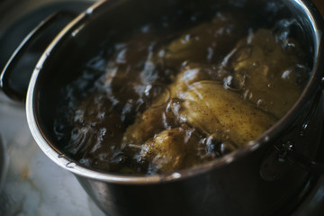 pot filled with potatoes and boiling water on a stove